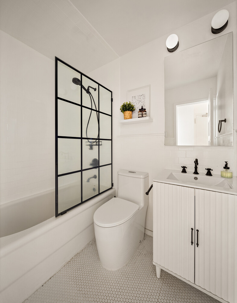 172 West 82nd Street, Unit 2A Manhattan, NY 10024 - Photo 8 of 9 a bathroom with a toilet a sink and mirror