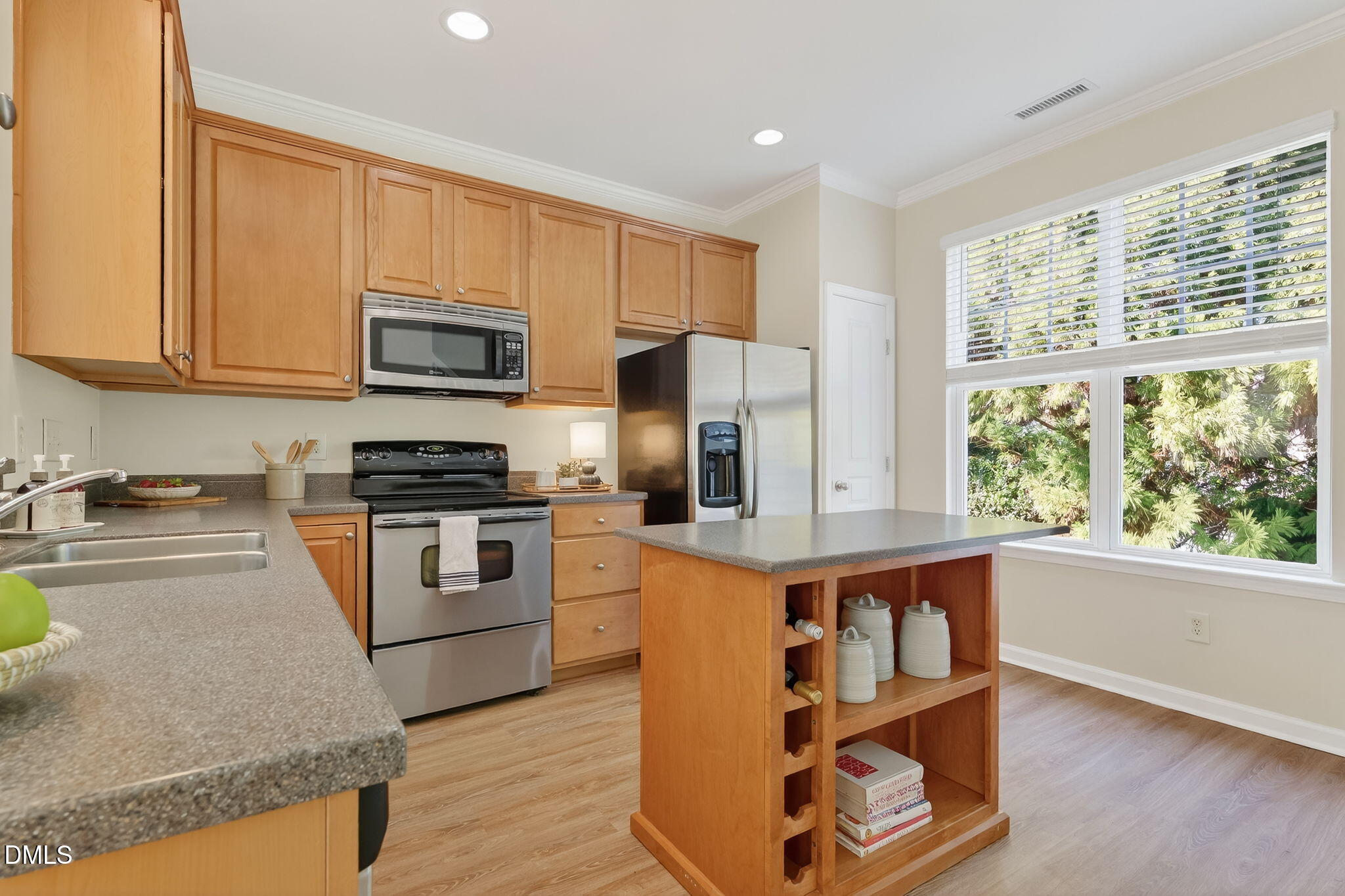 6041 History Trail Raleigh, NC 27612 - Photo 16 of 30 a kitchen with stainless steel appliances granite countertop a stove a sink and a microwave