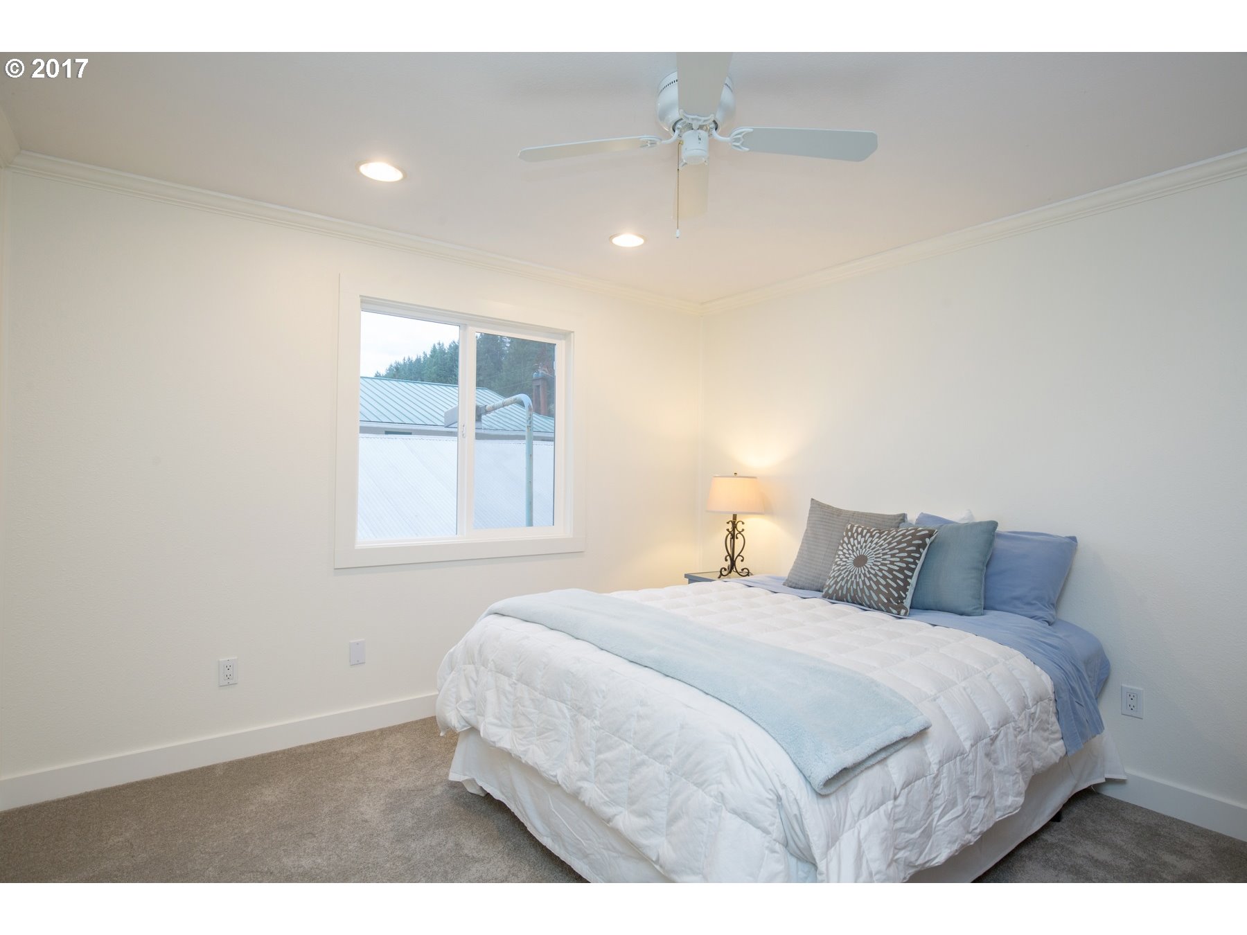 14468 Northwest Larson Road, Unit 3 Portland, OR 97231 - Photo 15 of 20 a bedroom with a bed and a window