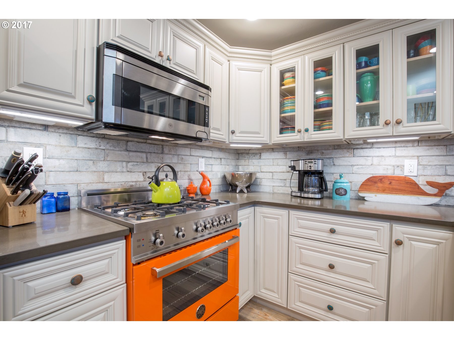 14468 Northwest Larson Road, Unit 3 Portland, OR 97231 - Photo 5 of 20 a kitchen with stainless steel appliances granite countertop a stove a sink and a microwave