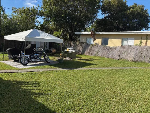 a view of a house with backyard porch and sitting area