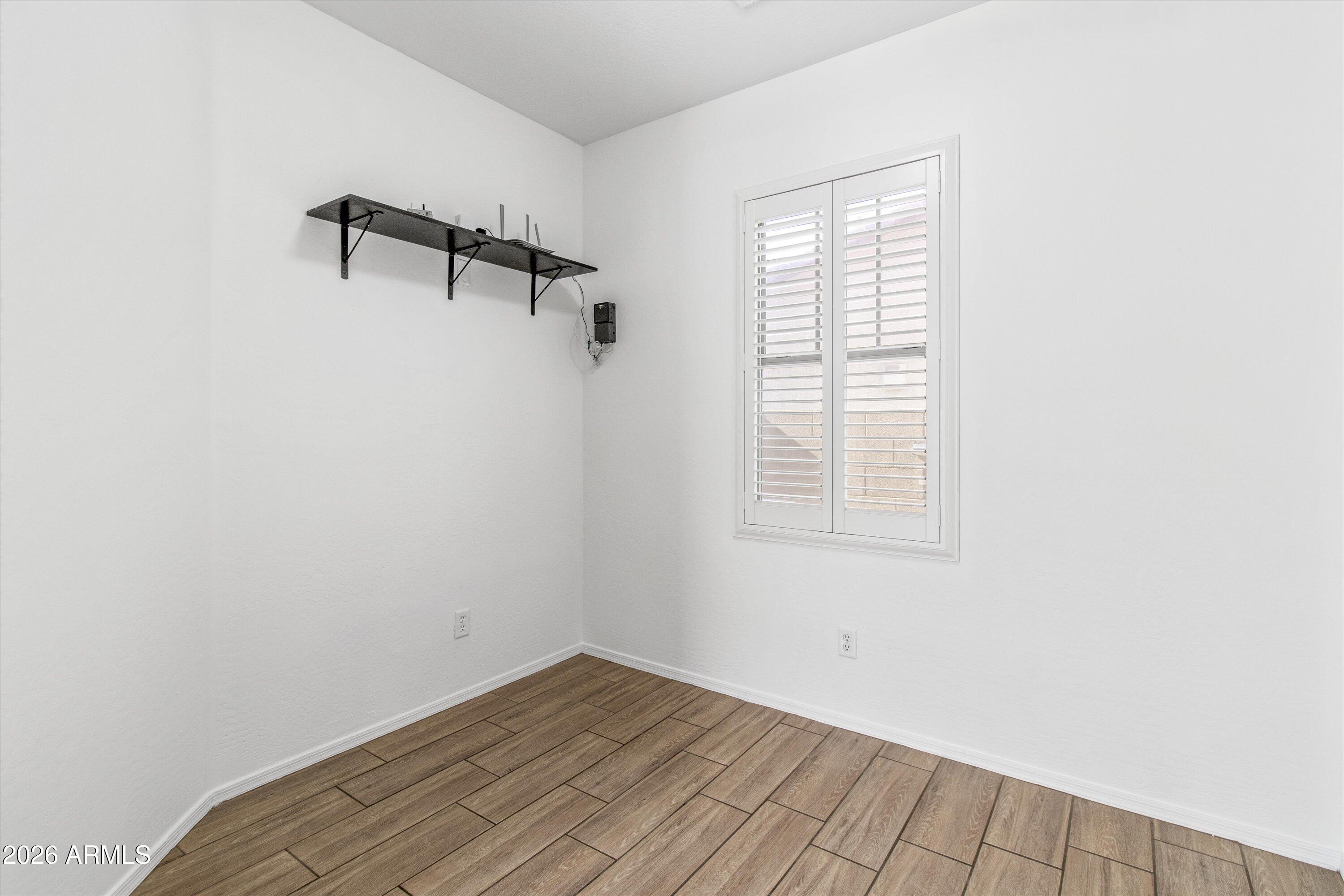 16510 West Tether Trail Surprise, AZ 85387 - Photo 11 of 47 a view of a room with wooden floor and windows