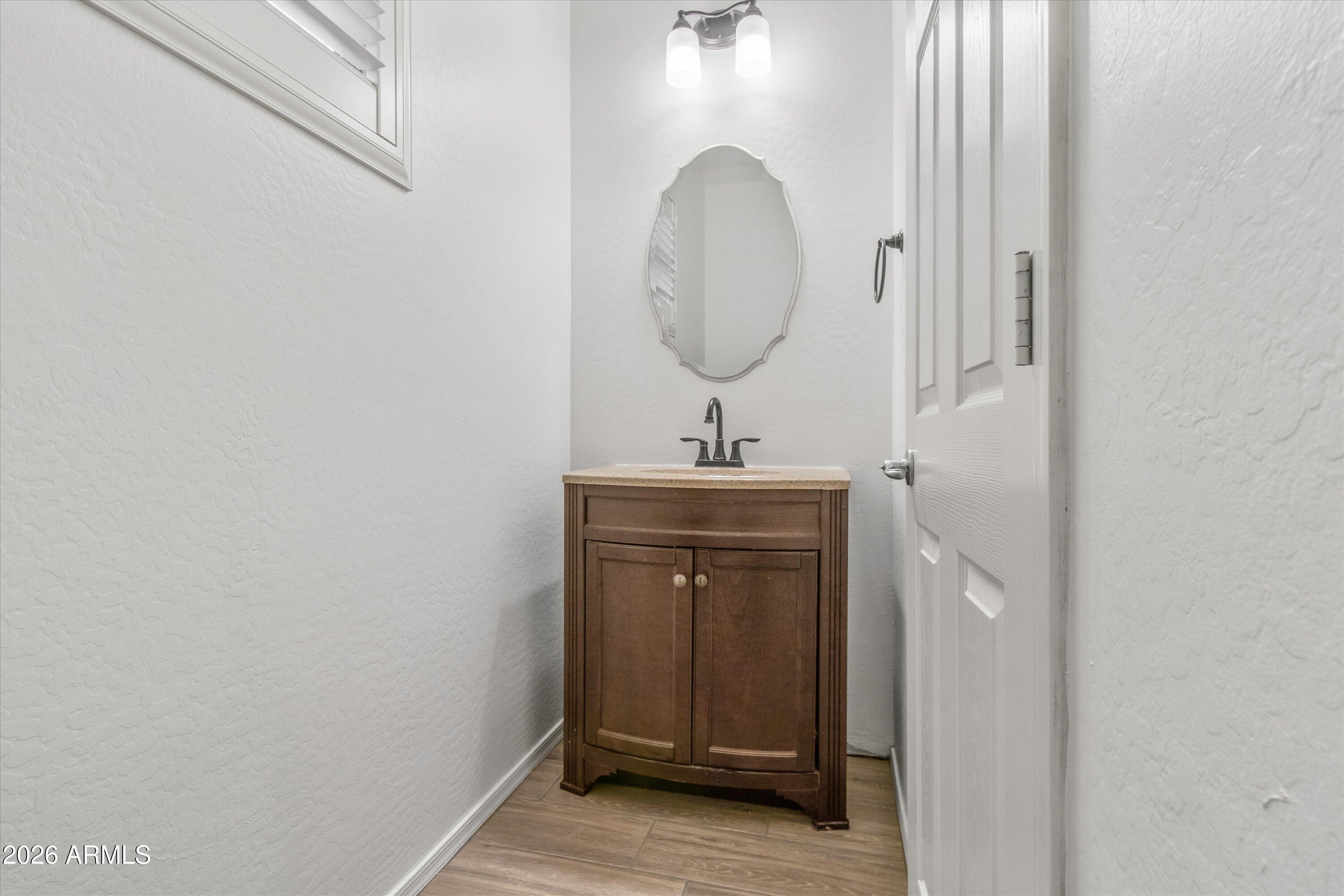 16510 West Tether Trail Surprise, AZ 85387 - Photo 12 of 47 a bathroom with a sink and a mirror
