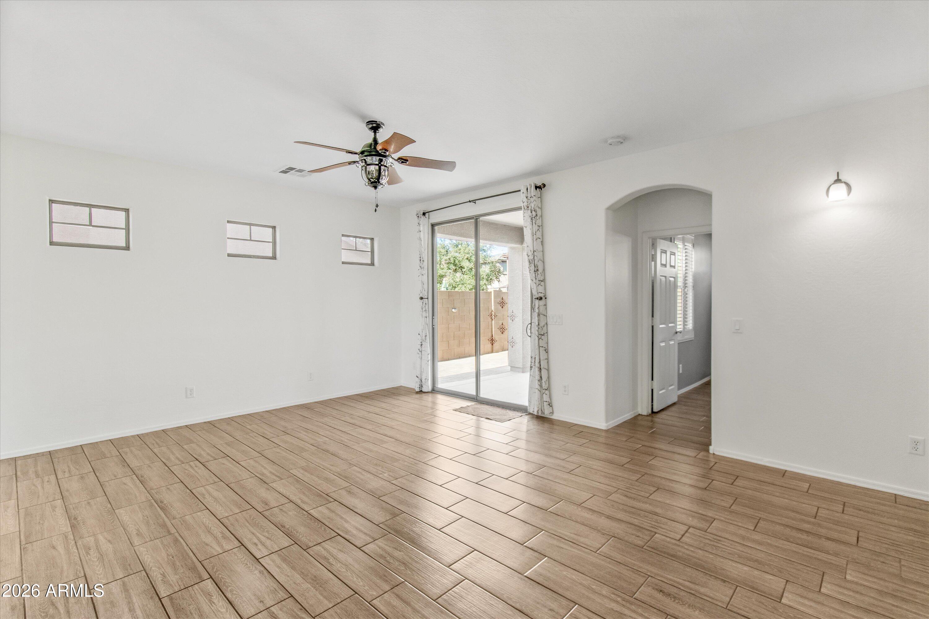 16510 West Tether Trail Surprise, AZ 85387 - Photo 14 of 47 a view of an empty room with window and wooden floor