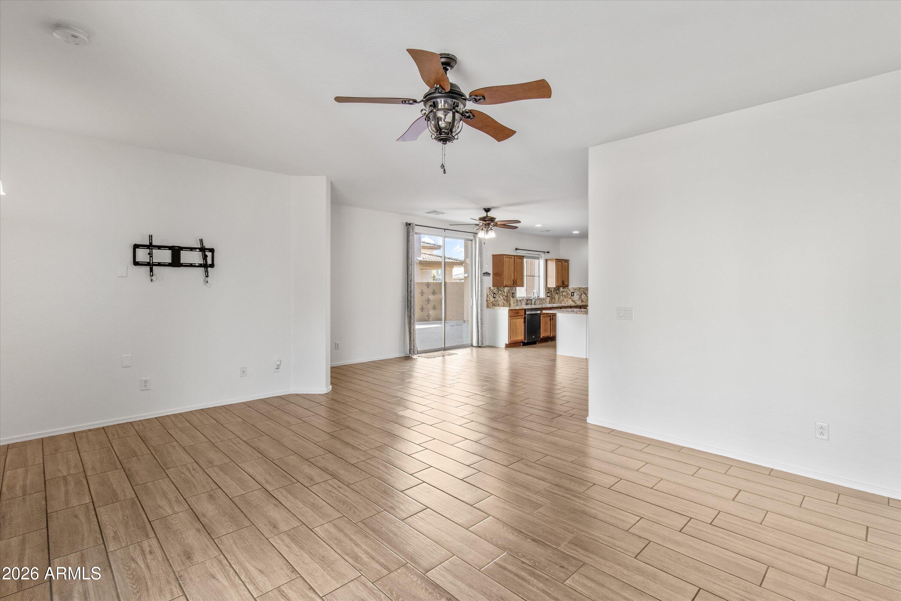 16510 West Tether Trail Surprise, AZ 85387 - Photo 15 of 47 a view of empty room with a window and wooden floor