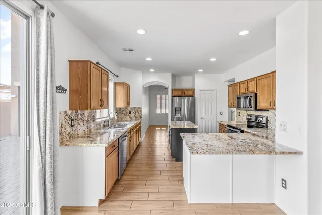 a bathroom with a granite countertop sink a large mirror and a shower