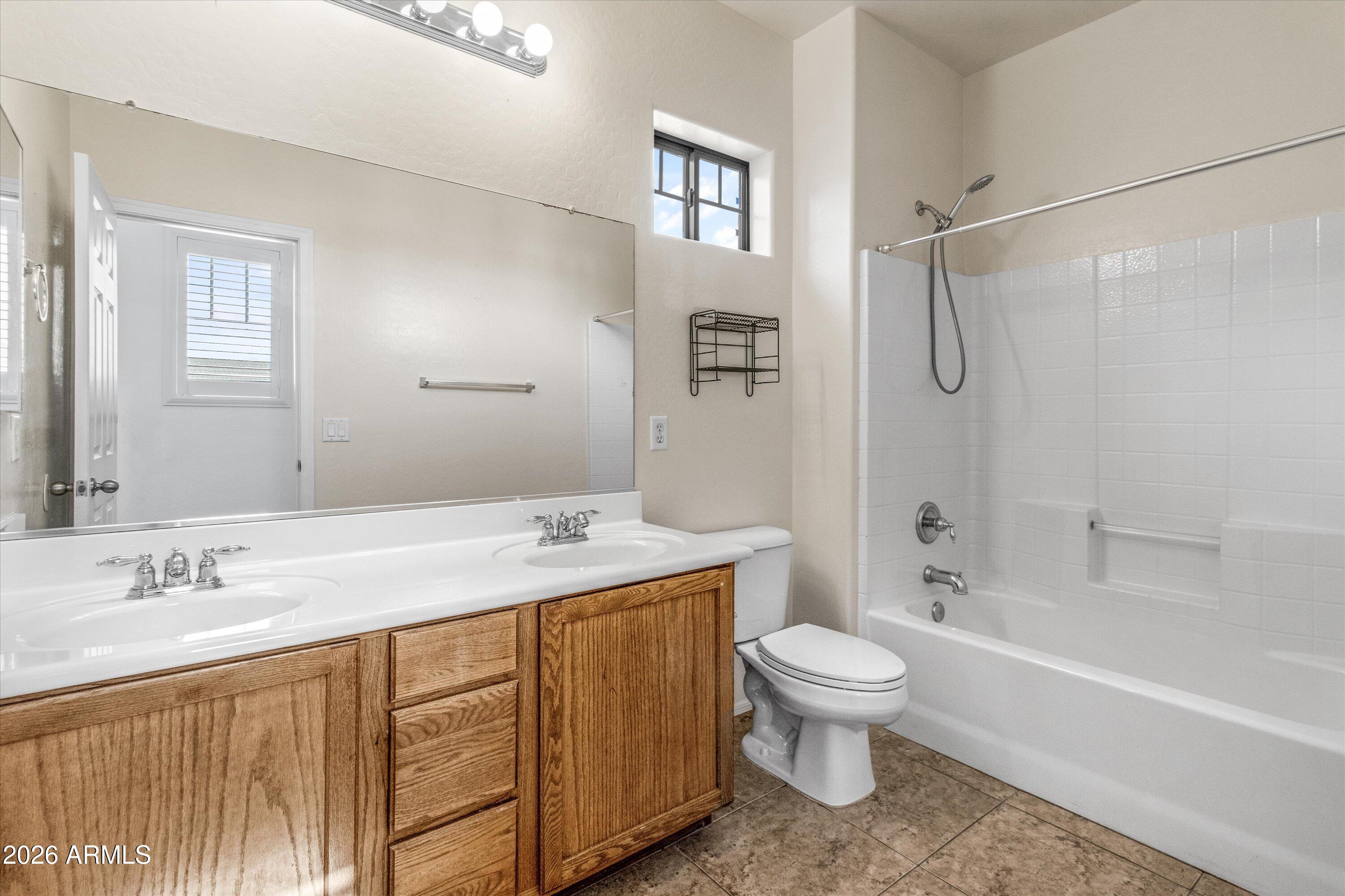 16510 West Tether Trail Surprise, AZ 85387 - Photo 19 of 47 a bathroom with a sink a toilet and shower