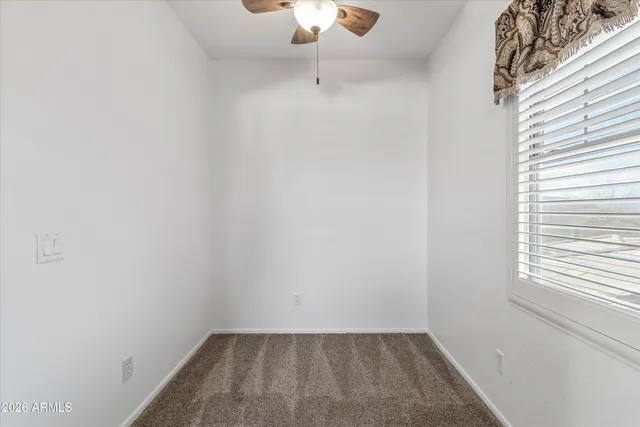 a spacious bathroom with a tub sink and mirror