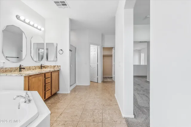 a bathroom with a granite countertop toilet a sink and bathtub