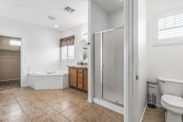 a bathroom with a granite countertop sink a mirror and shower