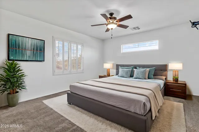 a bedroom with a large bed and a window