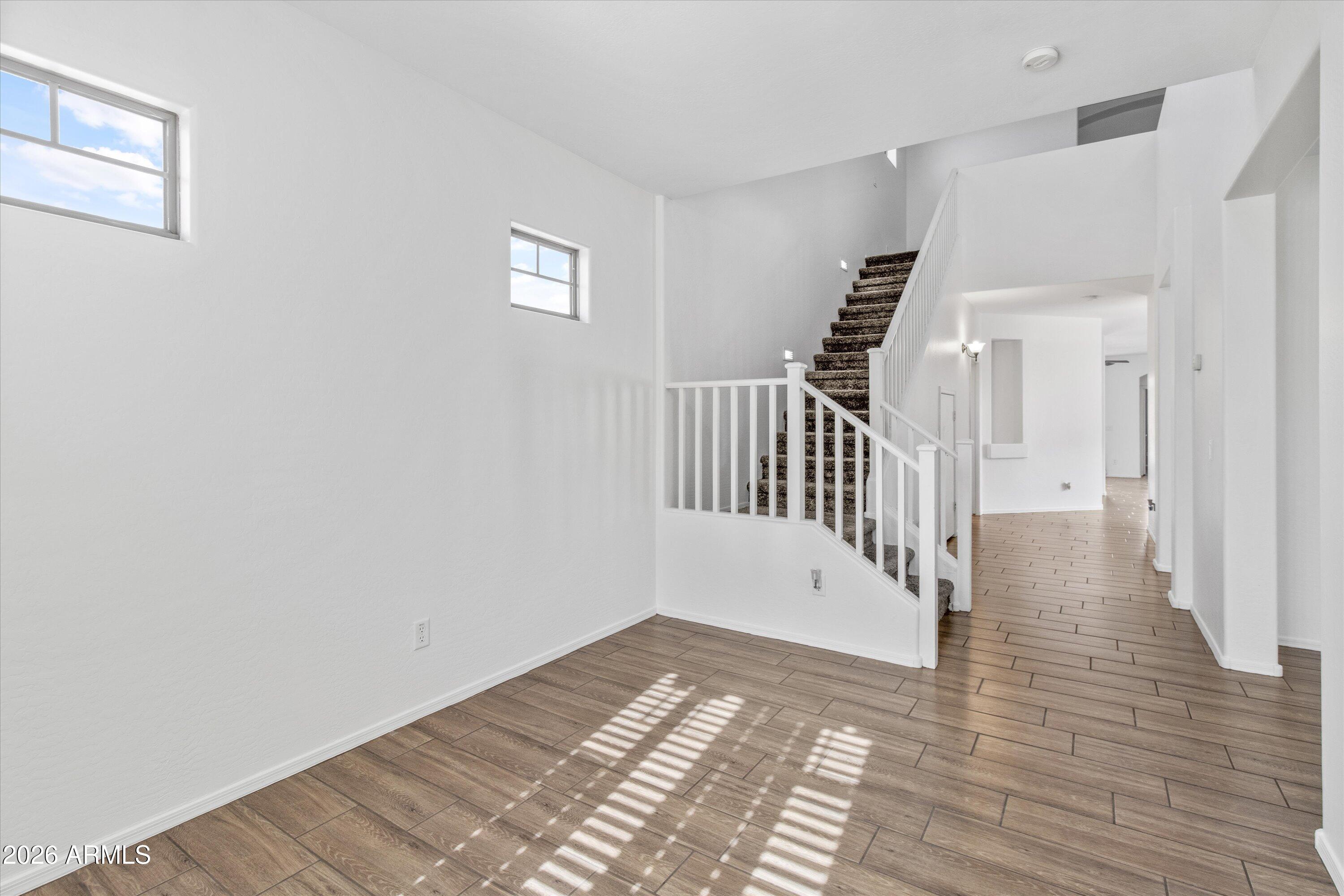 16510 West Tether Trail Surprise, AZ 85387 - Photo 9 of 47 a view of a hallway with wooden floor and windows