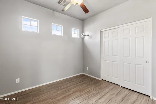 a view of a room with wooden floor and windows
