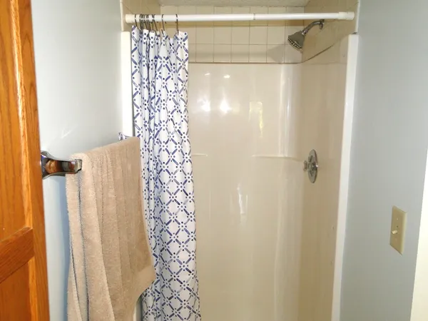 a bathroom with a shower curtain and a shower curtain