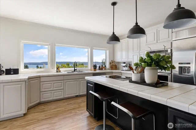 a kitchen with sink cabinets and wooden floor
