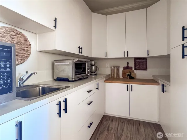 a kitchen with a sink and cabinets