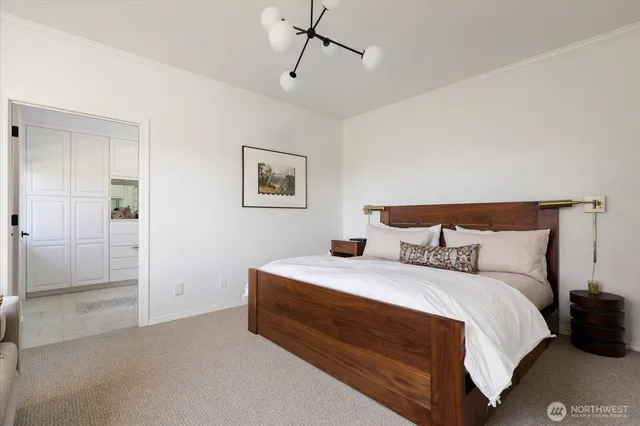 a bedroom with a bed and a painting