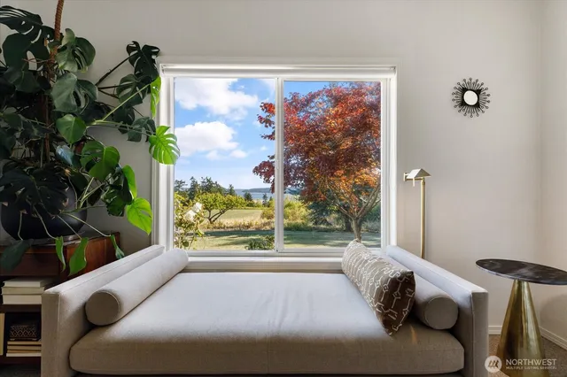 a bed sitting in a bedroom next to a window