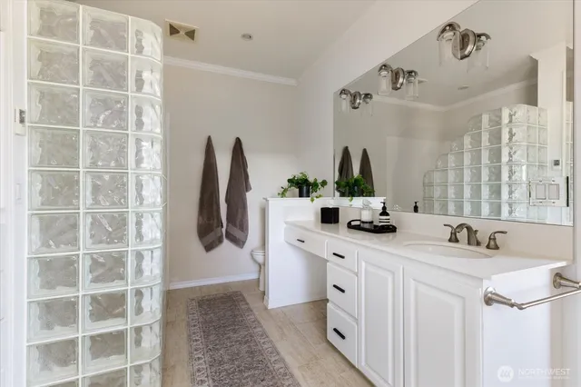 a bathroom with a double vanity sink a mirror and a shower