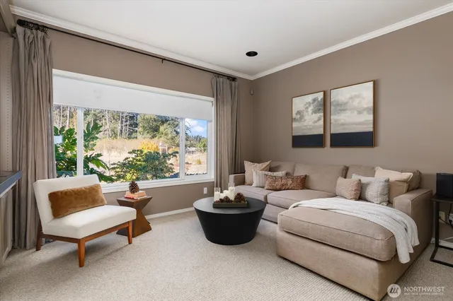 a living room with furniture a lamp and a large window