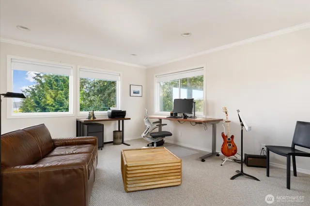 a living room with furniture gym equipment and a large window