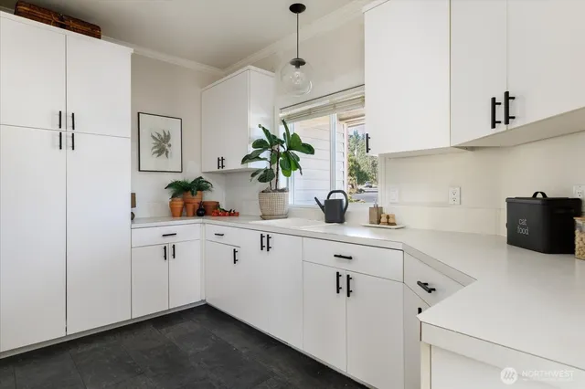 a kitchen with cabinets and window