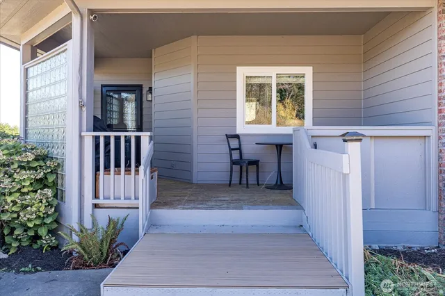 a view of a house with a small yard and wooden floor and fence