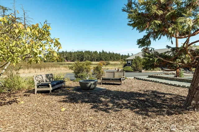 a backyard of a house with table and chairs