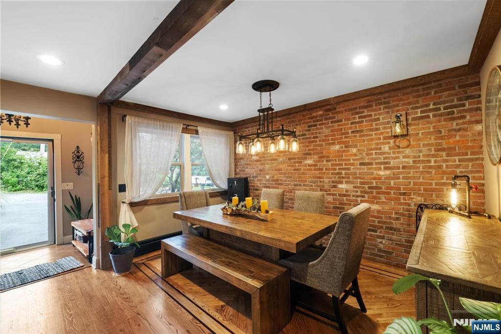 a reading room with furniture wooden floor and a large window