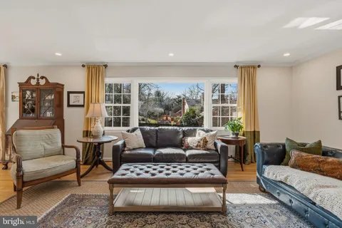 a view of a dining room with furniture wooden floor and a chandelier