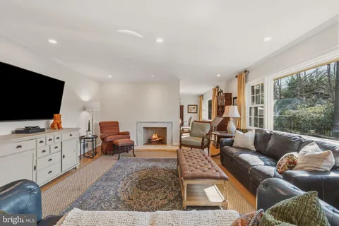 a dining room with furniture a chandelier and wooden floor