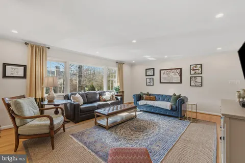 a dining room with furniture a chandelier and wooden floor