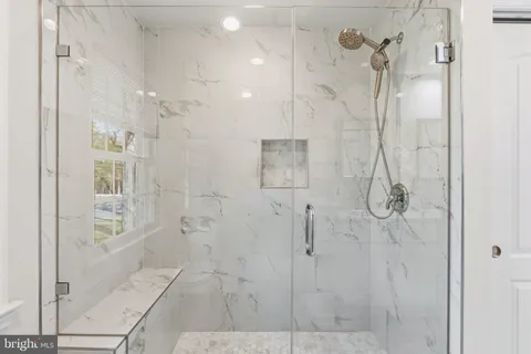 a bathroom with a tub and a window