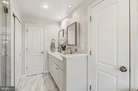 a bathroom with a sink vanity and a mirror