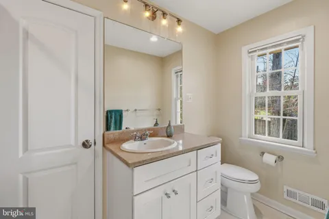 a living room with fireplace furniture and a large window