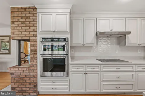 a view of a dining room with furniture wooden floor and chandelier