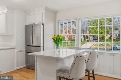 a living room with furniture and a large window with garden view