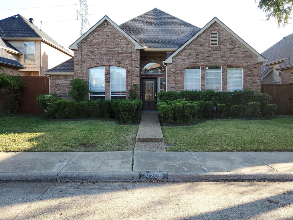 4208 Windhaven Lane Dallas, TX 75287 - Photo 1 of 1 a front view of a house with a yard and garage