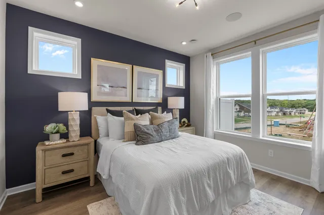 a bedroom with a bed and large window