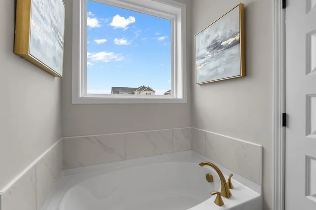a bath tub sitting next to a window