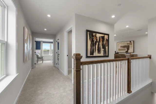 a view of a hallway with windows and entryway