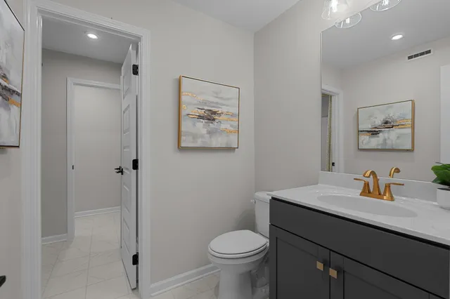 a bathroom with a sink toilet and vanity