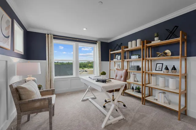 a view of a workspace with furniture and a bookshelf