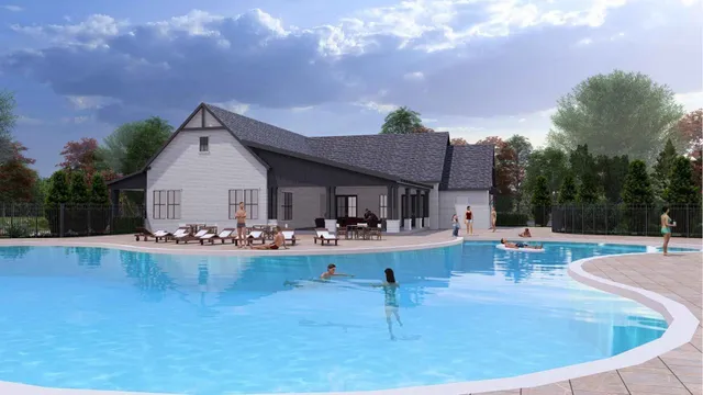 a view of a house with swimming pool and sitting area