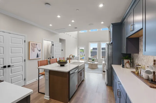 a kitchen with sink stove and cabinets