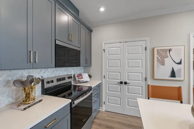 a kitchen with stainless steel appliances granite countertop a sink and cabinets