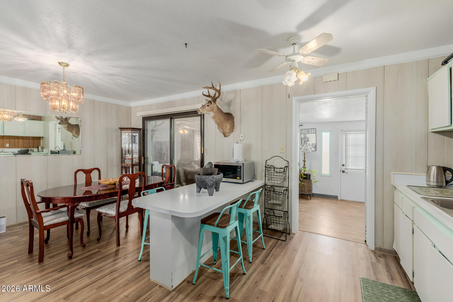 420 West 6th Street Ajo, AZ 85321 - Photo 13 of 35 a view of a dining room and livingroom with furniture wooden floor a chandelier