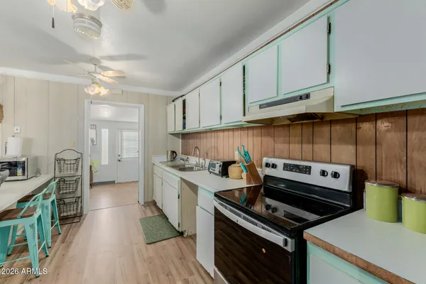 a kitchen with a stove a sink and a refrigerator