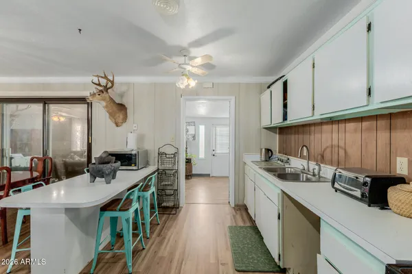 a kitchen with a sink appliances and cabinets