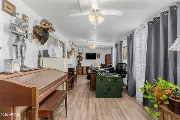 a living room with lots of furniture hardwood floor and a kitchen view